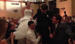 The newly married Abby and Sam dance the Hora, or traditional Jewish wedding chair dance.